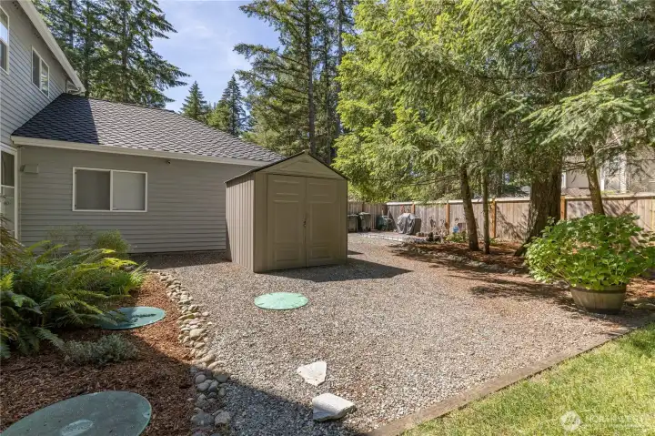 Side yard with garden shed, laundry room access, and convenient access for septic maintenance.