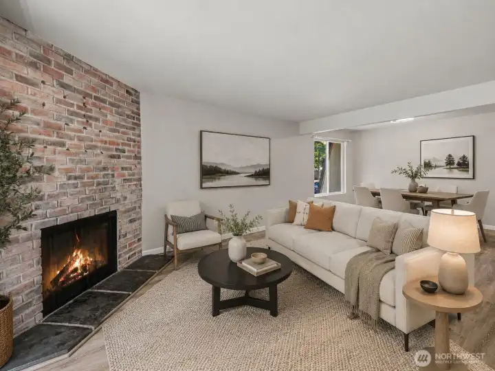 Living area looking towards dining area with  AI staged with couch in center