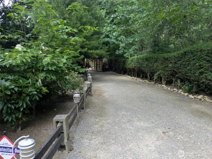 Driveway onto the property nestled in a peaceful, serene setting. Driveway onto the property nestled in a peaceful, serene setting.