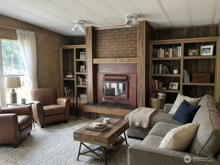 Cozy family room with wood-burning fireplace insert (virtually staged) Cozy family room with wood-burning fireplace insert (virtually staged)
