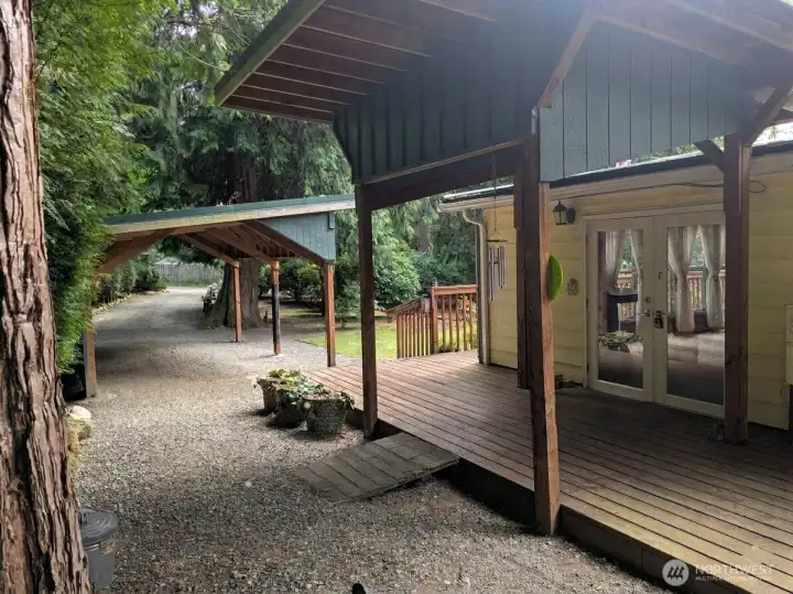 Covered front deck entry & covered carport. Metal roof 10 yrs old. Covered front deck entry & covered carport. Metal roof 10 yrs old.