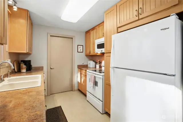 Door from kitchen opens to hallway off garage.