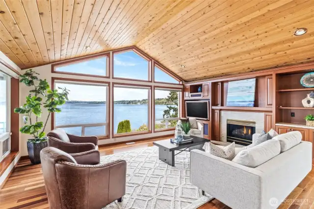 Great room with built-in, hardwood floors and gas fireplace. View looking north.