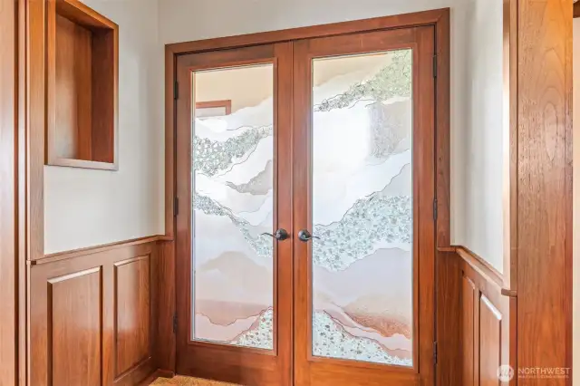 Entrance to primary suite with beautiful etched glass doors.