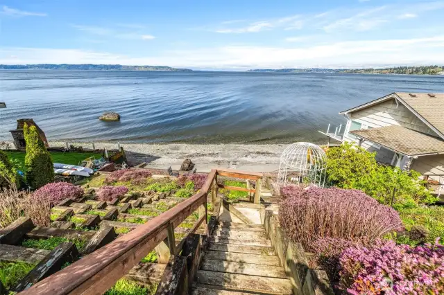 Stairs leading to your sandy beach with terraced gardens.