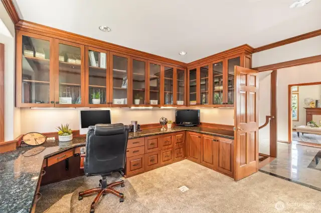 Large office with lots of counter space and beautiful built-ins.