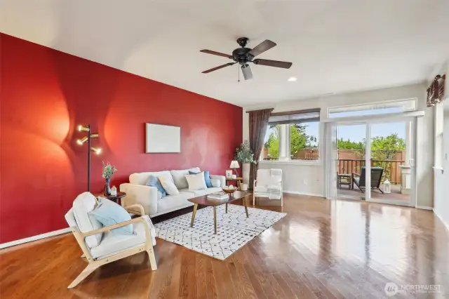 Living room complete with sliding door to access deck and ceiling fan