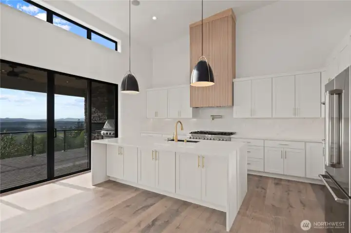 Gourmet kitchen w/waterfall quartz slab countertops...