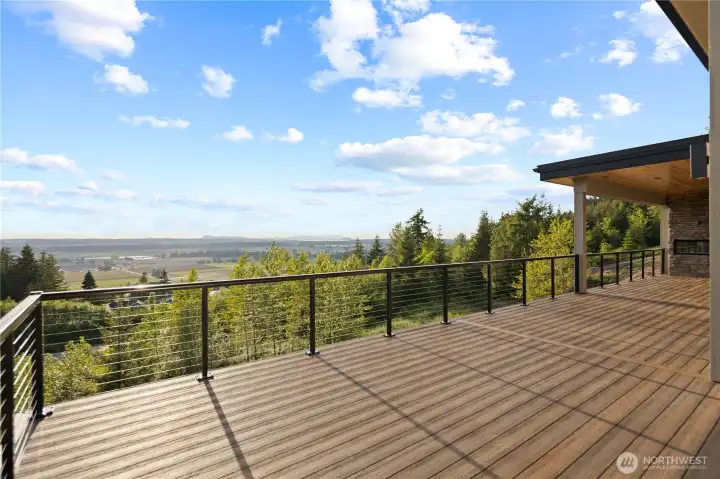 Step out to your big deck, w/covered area including built-in grill & fireplace.