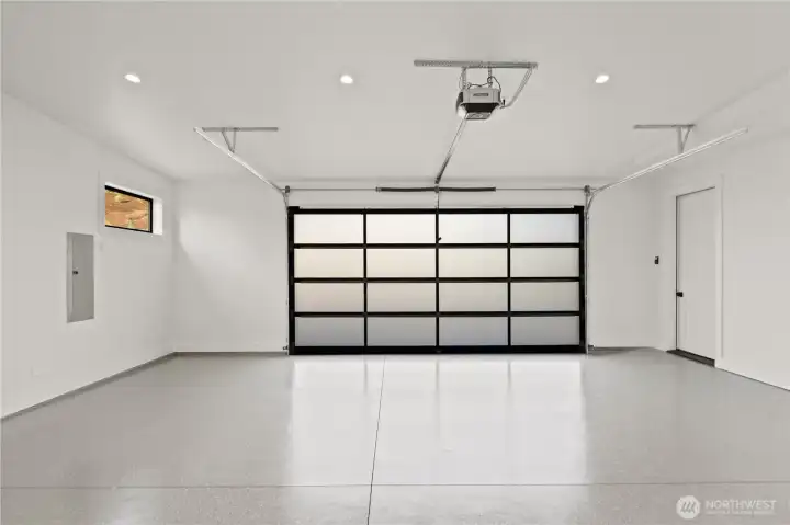 Finished garage w/epoxy full flake floors & modern door.