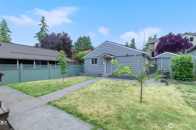 Fully fenced yard with space for gardening or play.