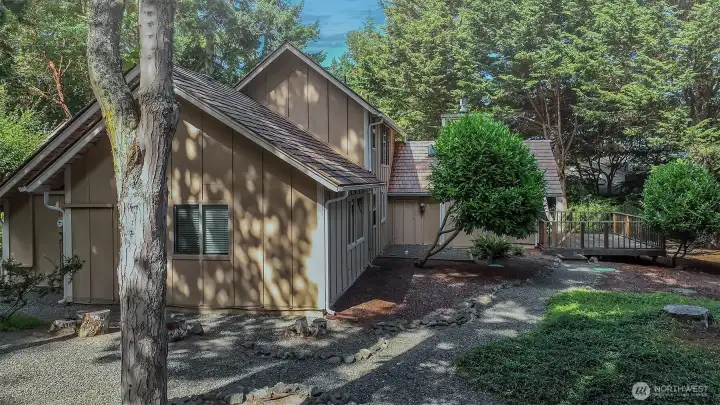 Closer in seeing primary bedroom side room window, office windows off primary in middle and home stretching out to the deck in the back.