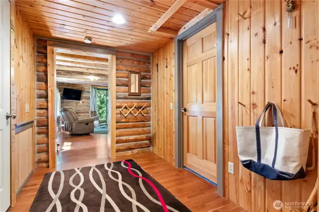 The wood-paneled entry has lots of room for coats and boots and leads to both the older and newer wings of the house.