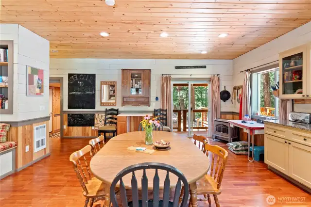 The kitchen features a pellet stove for wintertime warmth and sliding doors that lead to the deck for summertime BBQs.