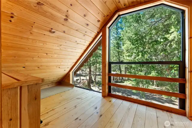 The dormer features a sunroom that overlooks the forest below.