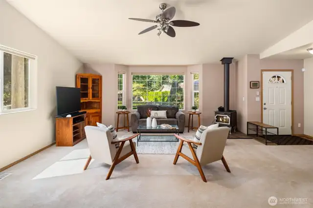 The entry of this home opens to the great room and features vaulted ceilings and a cozy fireplace.