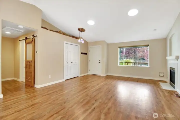 Living room with big window out to the front yard.