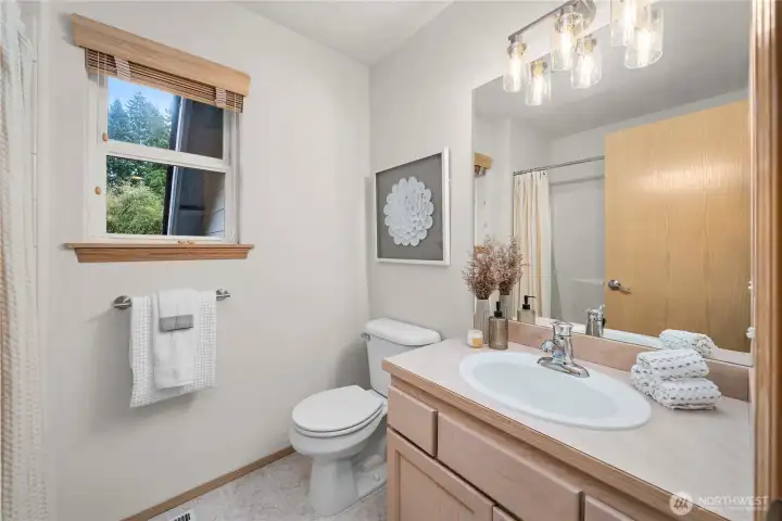 Upstairs guest bath with clean finishes and plenty of natural light.