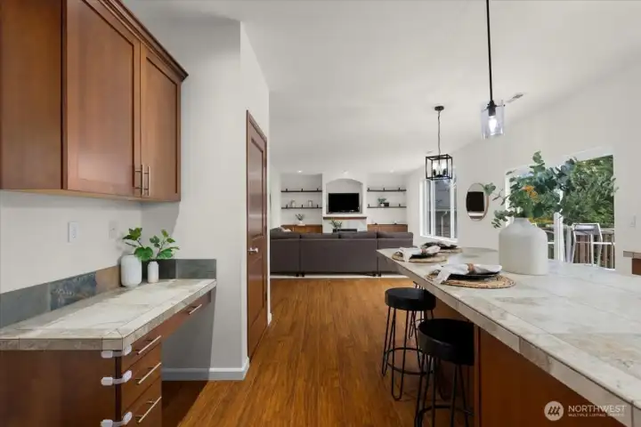 Kitchen opens to great room with gas fireplace creates warmth and a welcoming vibe for gatherings.