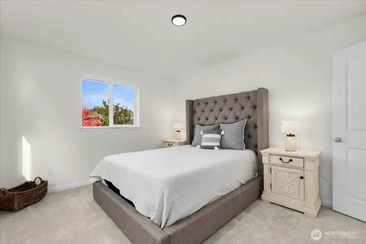 Spacious second bedroom with abundant natural light.