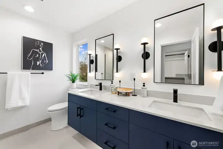 Dual sinks in the primary bathroom. The shower is to the left.