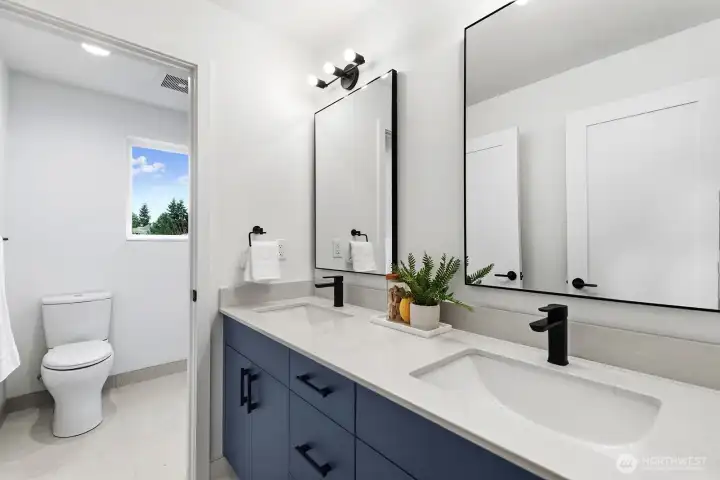 Dual sinks in the shared full bathroom.