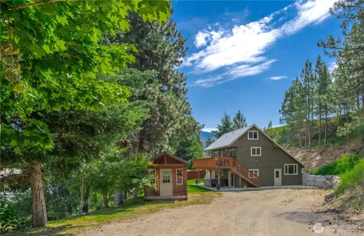 Driveway entrance w/ storage shed, spacious parking area & RV parking w/ 30-amp electric service, septic & water hookups.