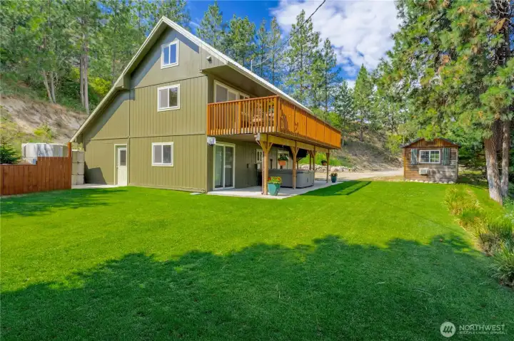 Exterior view of home w/ grassy landscaped yard.