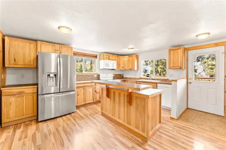 Upper Level Kitchen - View towards door leading to upper level view deck w/ outdoor living area.