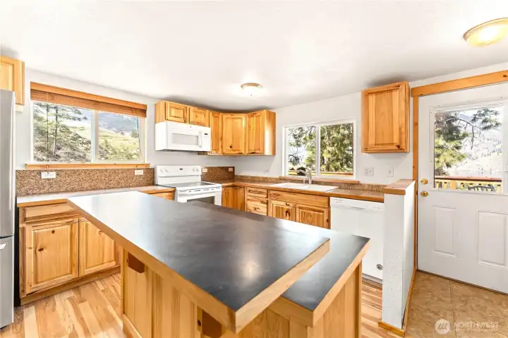 Upper Level Kitchen - View towards door leading to upper level view deck w/ outdoor living area.