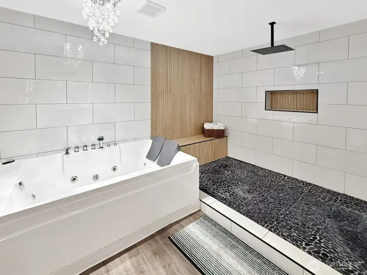 Spa-inspired en suite bath with a stunning full wall of designer tile creating a true luxury retreat feel.
