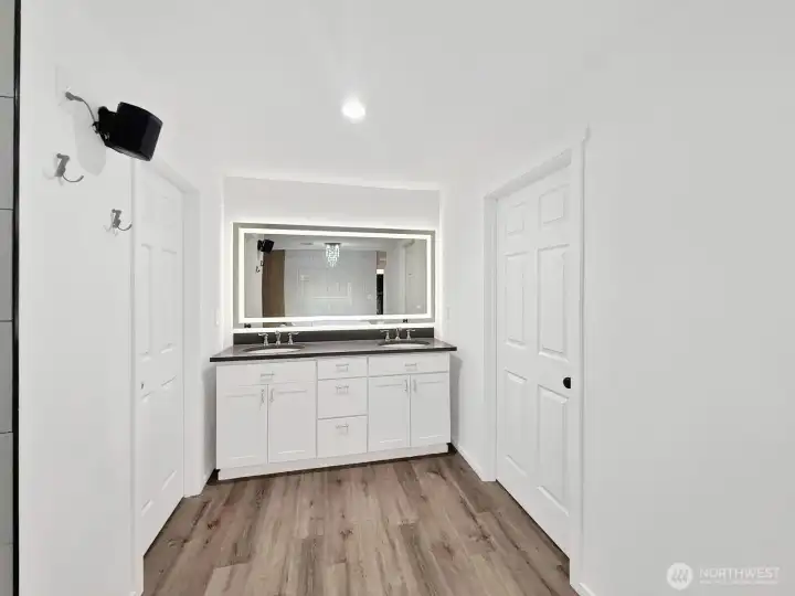 Lighted mirror adds a modern glow over a beautiful new dual sink vanity.