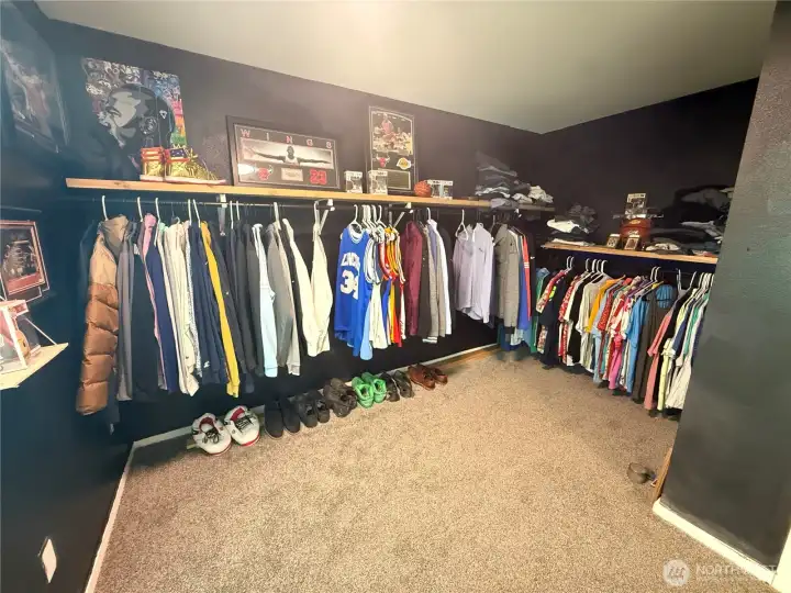 Clean, custom walk-in closet with a strong, modern feel.