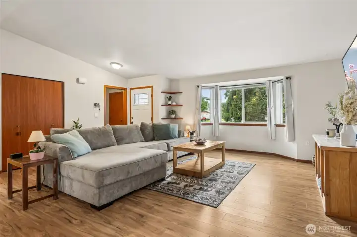 The new entry door opens into a bright, inviting space that immediately feels like home. It’s the perfect introduction to the open, airy floor plan that defines this rambler. Laminate flooring, vaulted ceilings, and a large bay window and a Great Room Floor Plan bring in lots of natural light.