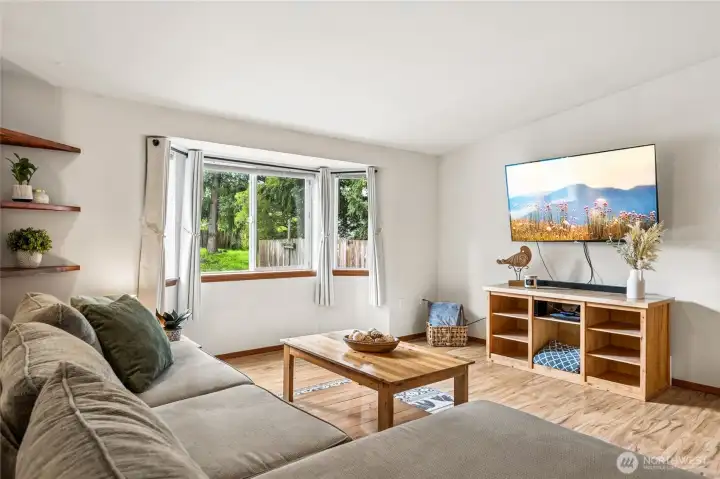 Vaulted ceilings and abundant natural light make the living room feel spacious and uplifting. This is a space designed for cozy evenings, movie nights, and effortless gatherings.