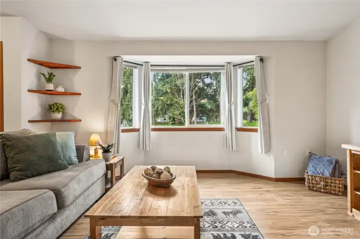 The bay window fills the living room with natural light and views of the front yard. The main living area features durable LVP flooring that stands up beautifully to daily life. Smart switches and upgraded Wi-Fi wall heaters bring modern comfort and efficiency to the home. These thoughtful updates enhance your daily routine and reduce energy waste.