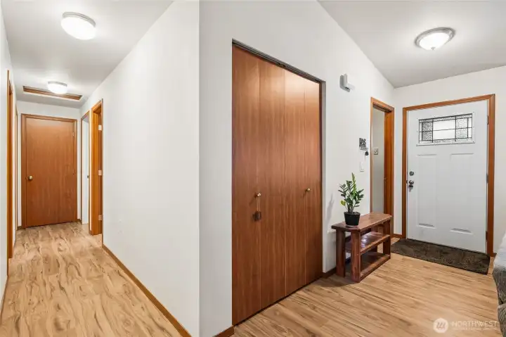 New Entry door added and garage entry through the dedicated utility room to left of entry door. Current coat closet is nicely set up for additional storage.