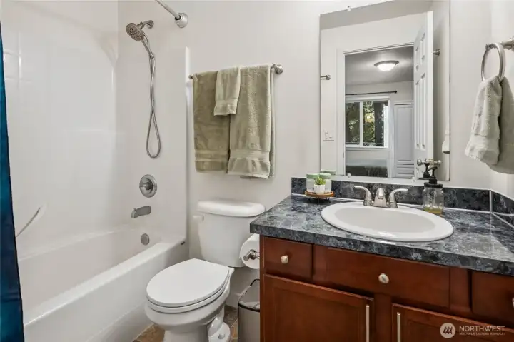 Full Primary Bath with cherry cabinetry.