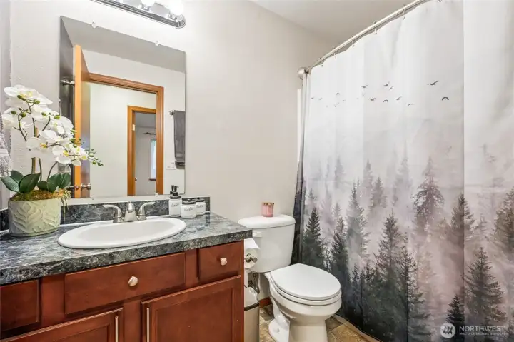 The full guest bathroom offers modern convenience and a clean, welcoming design.