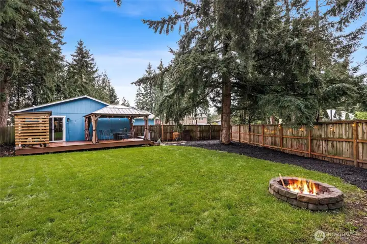 At dusk, the home glows with warmth and charm, highlighting its inviting design. It’s a beautiful reflection of the comfortable, welcoming lifestyle this rambler offers. Enjoy evenings around the firepit roasting hotdogs, making smores and creating memories for years to come.