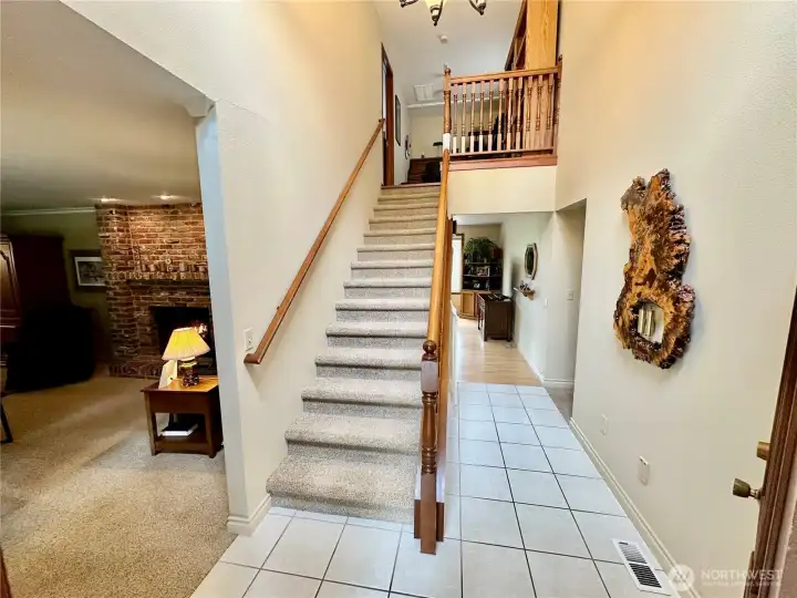 Just off the entry sits the stairwell to the primary bedroom, office and 5 piece bath.