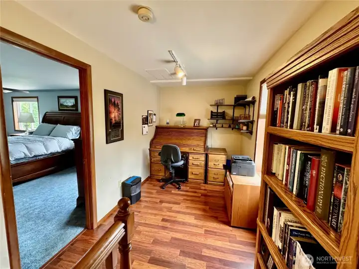 The upper floor den/office is located just off the master bedroom with laminate floor and large picture window for natural light.