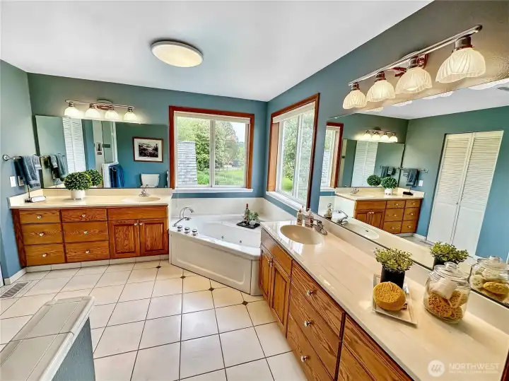 Beautiful primary bath with heated tile floor double vanities and steam shower.