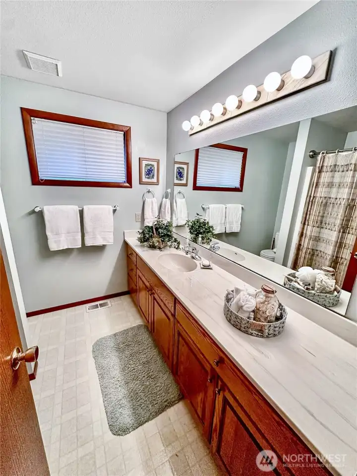 Main floor, full, hall bath centrally located near the two guest bedrooms.
