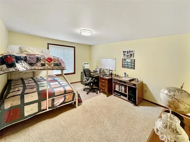 3rd main floor bedroom with plenty of room for beds and office space.