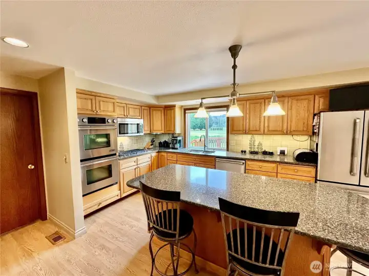 Just off the kitchen is the large laundry room with access to the attached garage and backdoor entry.