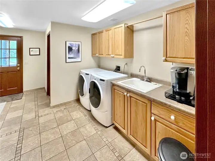 Large laundry room?  This home has it plus upper and lower cabinets, half bath and access from the outside, garage and kitchen.