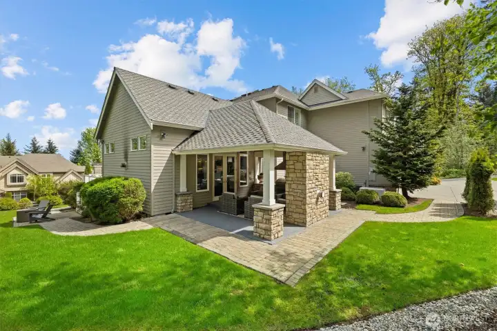 View of the landscaped yard with the outdoor living area