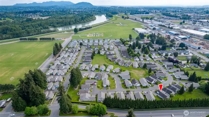Aerial view of the community. Just a short stroll to Skagit River Park with Dike Trails, playgrounds and playfields!