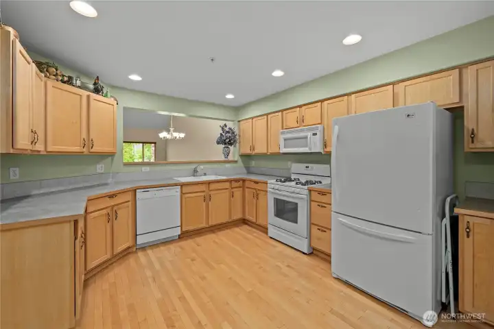 The huge kitchen features maple cabinets and solid maple floors. The huge kitchen features maple cabinets and solid maple floors.